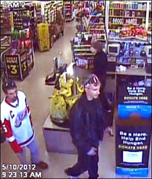 Toledo Police are attempting to identify two suspects attempting to use a stolen credit card that was taken from a motor vehicle.