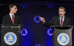 U.S. Sen. Sherrod Brown, D-Ohio, right, debates Republican challenger, Ohio state treasurer Josh Mandel, at the City Club in Cleveland.