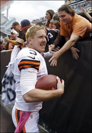 Cleveland Browns quarterback Brandon Weeden celebrates with fans after an NFL football game against the Cincinnati Bengals in Cleveland.