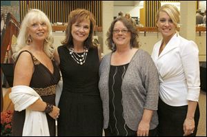 Adopt America Network board member Letitia Marth, left, board chair Sharon Gillespie, center left, President of Adopt America Wendy Spoerl, center right, and Jessica Ransom.