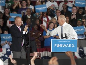 Former Ohio Gov. Ted Strickland applauds as Vice President Joe Biden reacts from the crowd during a campaign stop today at the J. Babe Stearn Community Center in Canton, Ohio.