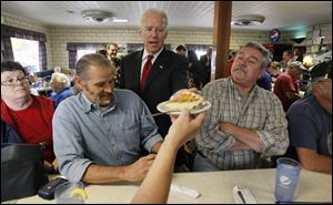 Vice President Joe Biden gets a piece of custard pie from Diane Haffen during a campaign stop at Schmucker's restaurant in Toledo.