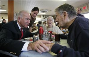 Vice President Joe Biden, with his daughter Ashley Biden, standing, talks with Ed Nazar and his wife Ann Monaghan Nazar during a campaign stop at Schmucker's Restaurant.