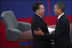 Republican presidential nominee Mitt Romney and President Barack Obama shake hands after the third presidential debate at Lynn University.