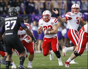 Nebraska running back Rex Burkhead takes the hand off from quarterback Taylor Martinez against Northwestern on Saturday in Evanston, Ill.