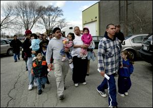 Workers who lost their jobs at WinCup because of their undocumented status showed up at the company in West Chicago, Ill., to claim their paychecks in March.