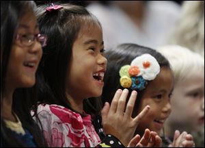 From left, Bella Strauss, 7, Lily Nofziger, 7, and Becca Strauss, 4, all of Wauseon, enjoy a special performance by the circus on Friday. The Chinese Association of Greater Toledo and the circus partnered to celebrate the  ‘Year of the Dragon’ by inviting local children from Chinese backgrounds and their parents to the show.