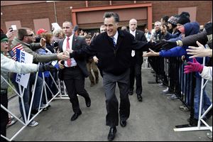 Republican presidential candidate and former Massachusetts Gov. Mitt Romney arrives to speak to an overflow crowd of supporters and as he campaigns at the Celina Fieldhouse in Celina, Ohio.