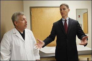 State treasurer Josh Mandel, Republican candidate for U.S. Senate, discusses his 10-point healthcare reform plan with Sylvania Township podiatrist Dr. Bruce Saferin.