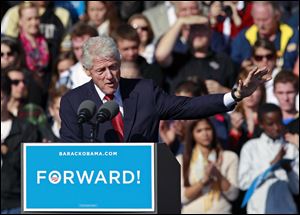 Former President Bill Clinton gestures while speaking at a campaign rally for President Barack Obama at the University of Central Florida in Orlando, Fla. President Obama cut short this Florida stop to head back to Washington to monitor Hurricane Sandy.