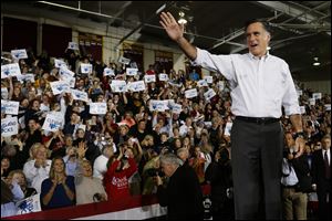 Republican presidential candidate, former Massachusetts Gov. Mitt Romney waves to supporters as he takes the stage at a campaign stop at Avon Lake High School in Avon Lake, Ohio, Monday.