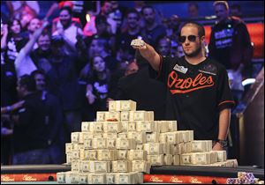 Greg Merson holds up his new bracelet after winning the World Series of Poker No-Limit Hold'em Main Event, today in Las Vegas.