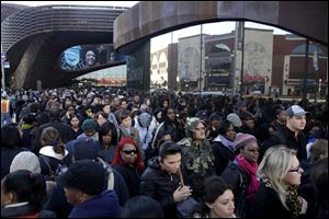 Commuters wait in a line to board buses into Manhattan in front of the Barclays Center in Brooklyn, New York. The line stretched twice around the arena and commuters reported wait times of one to three hours to get on a bus. 