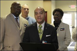 Rev. Cedric M. Brock, of Mt. Nebo Baptist and President of the Interdenominational Ministerial Alliance of Toledo, speaks about voting rights. Also pictured are, from left:  Rev. Willie Perryman, of Jerusalem Missionary baptist Church; Bob Lynn, of Toledo Jobs with Justice; and Pierette 