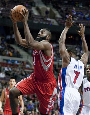 Houston Rockets guard James Harden goes to the basket past Pistons guard Brandon Knight during the first half Wednesday in Detroit.