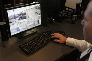 Toledo Police Sgt. S.D. Sterling operates one of the city's new surveillance cameras in a demonstration during Thursday's press conference at the Toledo Safety Building.