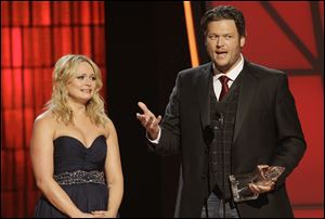 Miranda Lambert, left, and Blake Shelton accept song of the year award for 