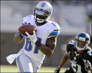 Detroit Lions wide receiver Calvin Johnson (81) catches a pass against Jacksonville Jaguars cornerback Derek Cox (21) during the second half of an NFL football game, Sunday, Nov. 4, 2012, in Jacksonville, Fla. Detroit beat Jacksonville 31-14. (AP Photo/Stephen Morton)