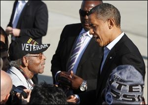 President Barack Obama talks today with World War II veteran Harkless Hutchings, 95, at  Rickenbacker International Airport in Columbus as he arrives for a campaign stop in Columbus.