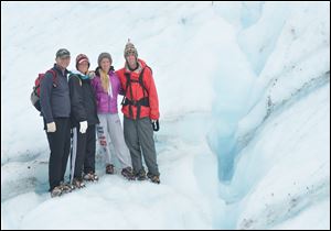 This 2011 photo provided by Lisa Kent shows her family, from left, Scott, Lisa, Peyton, and Tanner Kent, during a hike on the glaciers of Wrangell-St. Elias National Park in Alaska. The family has spent more than a decade visiting national parks during the holidays. 