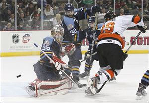 Walleye goalie Kent Simpson, 35, blocks the shot by Fort Wayne Komets player Stephon Thorne, 29, during the second period Wednesday at Huntington Center.