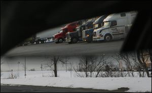 Tucked in the back of the Gables truck stop is ‘party row,’ reflected here in a rearview mirror.