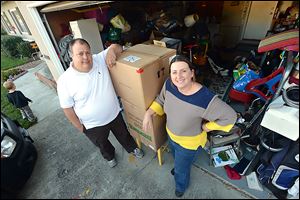 R.C., left, and Stacy Davis, of Dublin, have their photo taken in front of their garage at the home they are renting in Dublin, California. Three years ago the Davis's lost their Concord condominium to foreclosure. 