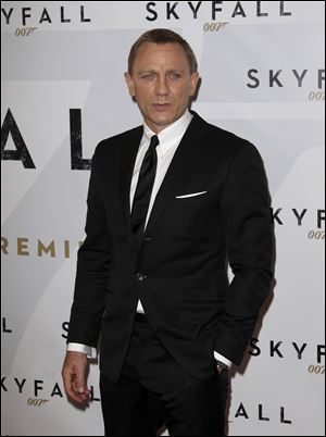 Actor Daniel Craig poses for photos as he arrives for the premier of the latest James Bond film, 