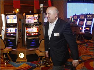 General Manager Richard St. Jean strolls through Hollywood Casino Toledo. He is upbeat about the casino's future despite declining revenue since June.