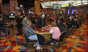 Bowling Green resident Mark Herzig deals blackjack at the casino, which features 2,037 slot machines, 80 table games, and 4 restaurants.