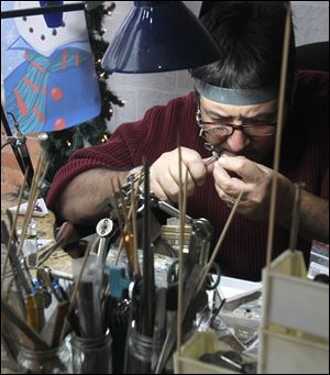 Jewelry maker Steven Kaminsky works at his Artforms glass and jewelry gallery in Perrysburg. The shop, which he owns with his wife, offers locally made pieces.