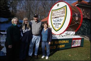 Project coordinator Bill Saul gathers with volunteers who helped paint and decorate the national battlefield park float that will appear in Ida’s Parade of Lights. From left are Darlene Belair, Becky Mullins, and Sandy Vanisacker. More than 120 floats are expected to be in the parade.