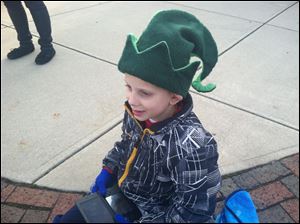 R.J. Otto, 8, of Perrysburg wears an elf hat Sunday as he watches his hometown's parade.