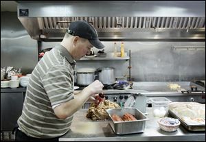 Rob Socie, owner of the Bulldog Diner, prepares meatloaf for the lunch rush. Mr. Socie chose the spot for his diner in Rossford after the casino issue passed and its location was selected. He would like more customers, but has seen a steady increase.