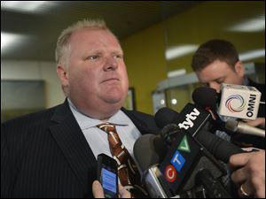 Toronto Mayor Rob Ford faces the media at city hall in Toronto, Monday, Nov.26, 2012.  Ford has been ordered out of office after a judge ruled Monday he broke conflict of interest rules. (AP Photo/THE CANADIAN PRESS,Nathan Denette)