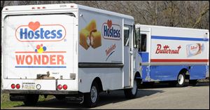 Trucks are parked at the Hostess bakery outlet  in Kalamazoo Township, Mich.