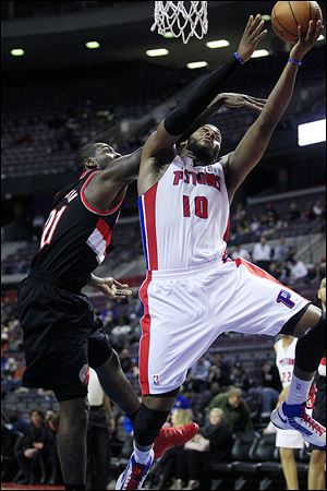 Detroit Pistons center Greg Monroe (10) is fouled by Portland Trail Blazers center J.J. Hickson (21) during the third quarter of an NBA basketball game at the Palace of Auburn Hills, Mich., Monday, Nov. 26, 2012. (AP Photo/Carlos Osorio)