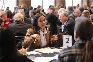 Rose Toth Gallardo of Rose Custom Interiors in Perrysburg speaks to her group during the table discussion. Toledo Mayor Mike Bell stressed the importance of working together to avoid missteps.