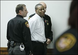 Daurin Patton is led from Judge Dean Mandros’ common pleas courtroom by sheriff’s deputies after he was found guilty of the murders of a Toledo mother and her son.