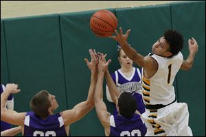 Clay's junior guard Patricc Both gets his fingers on a rebound during the third quarter of Friday evening's home game against Fremont Ross. Fremont Ross won, 68-41.