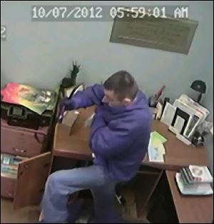 A surveillance camera caught this man apparently burglarizing a church in Lenawee County. Authorities say 50 churches in nine counties have been robbed.