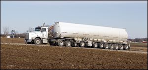 A tanker leaves a facility near Adrian. As of 2010, the U.S. government says the nation uses about 19 million barrels of oil a day.