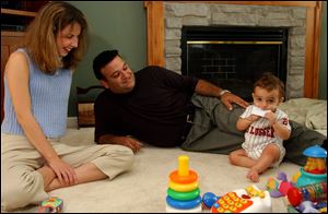 Jennifer Makhlouf and her husband, Joe, watch their son Anthony in their Lambertville, Mich. home. The Makhloufs used preimplantation genetic diagnosis to make sure they made a healthy embryo.