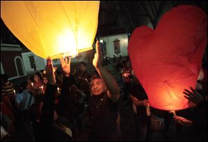 People release sky lanterns during a vigil in support of Venezuela's President Hugo Chavez in Caracas, Venezuela, Thursday. Chavez is recovering favorably despite suffering complications during cancer surgery in Cuba, his vice president Nicolas Maduro said.