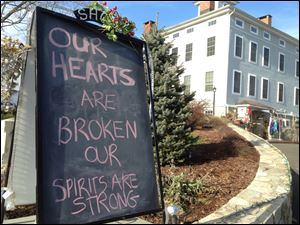 A condolence sign sits in downtown Sandy Hook, Conn., on Saturday.  