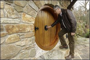 Architect Peter Archer enters the Hobbit house by opening a knob in the center, just as J.R.R. Tolkient described. Mr. Archer and his team designed the dwelling to fit in with the 16-acre property, and the stone was taken from a collapsed wall that runs through the land.