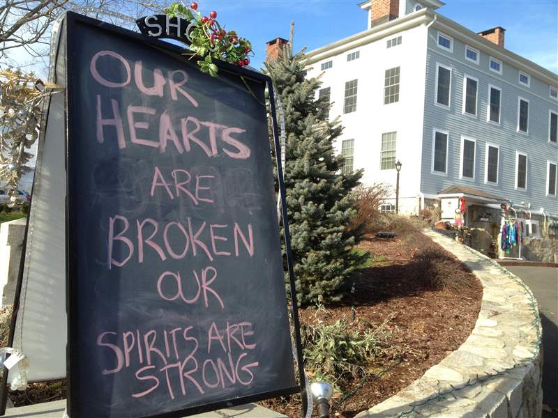 A-condolence-sign-sits-in-downtown-Sandy-Hook