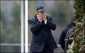 A mourner arrives at a funeral service in Fairfield, Conn., for Noah Pozner, 6, one of two funerals held Monday for school shooting victims.