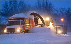 Crews in Pine Island, Minn., were out early clearing roads before commuters headed to work as the first big snowstorm of the season struck Thursday.