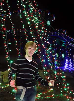 Drake Doren, 15, a sophomore at Bowling Green High School, starts his set-up in September, and then must program each accompanying beat of music to the thousands of lights.